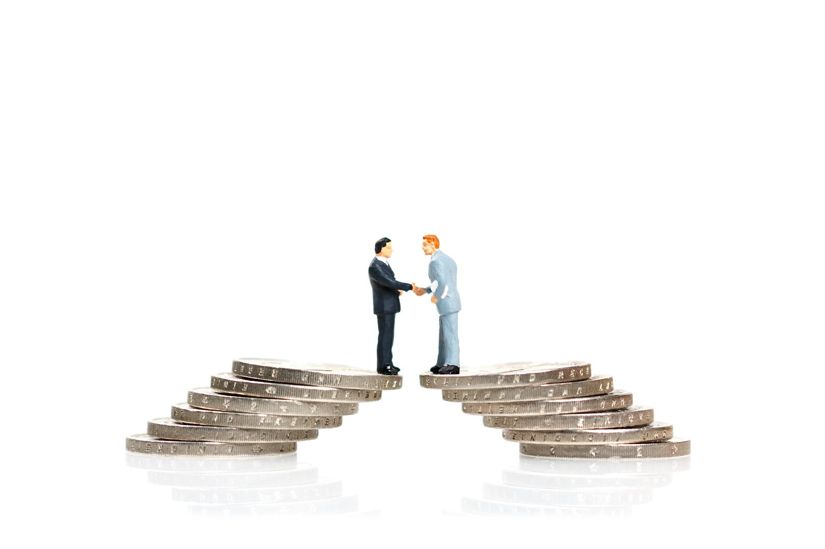 Handshake of two business man on a bridge of coins